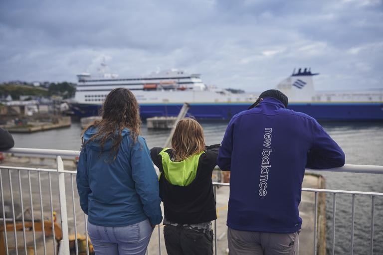 A family of three looking at a Marine Atlantic ferry